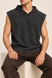 Seated view of Soft Static Hooded Tank in Black, showing the loose drape and unprinted washed fabric.
