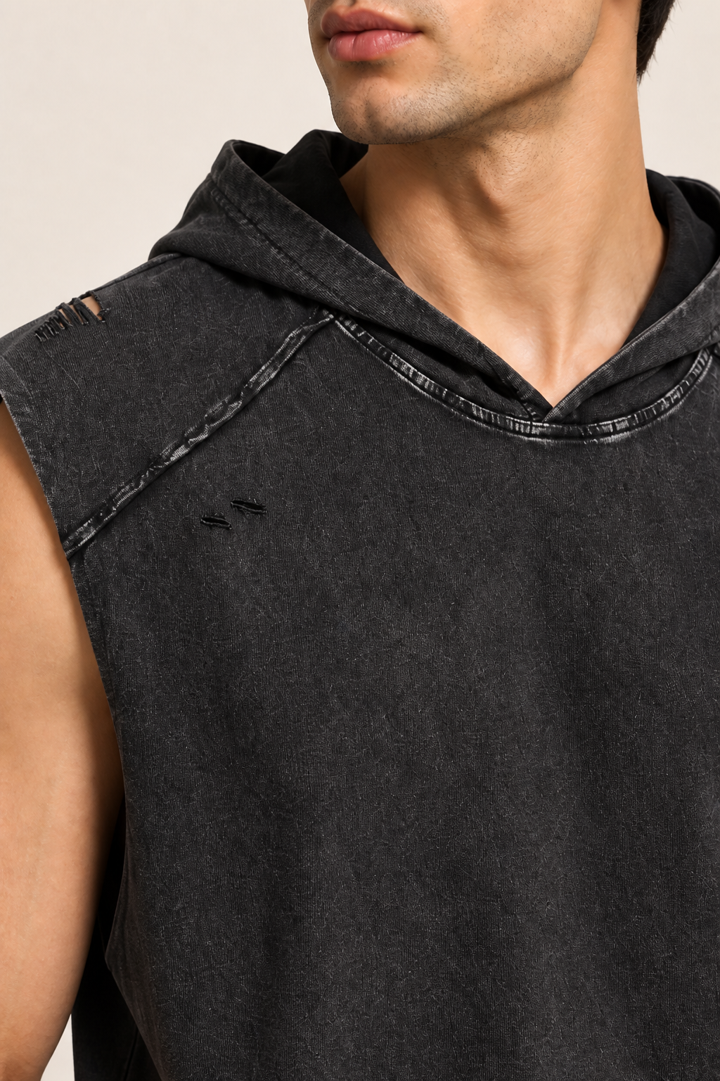 Detail of Soft Static Hooded Tank in Black, showing the hood neckline, raw shoulder seam and subtle distressing.