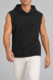 Walking view of Quiet Drift Sleeveless Hoodie in Black, showing the relaxed drape and sleeveless shape.