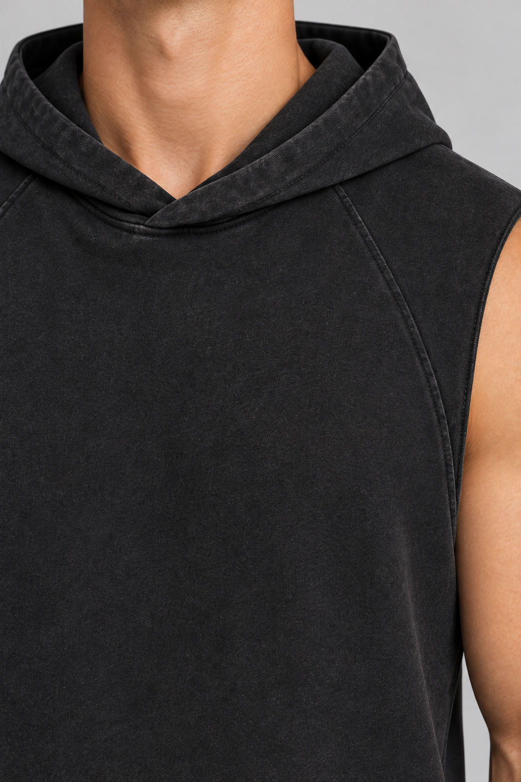 Detail of Quiet Drift Sleeveless Hoodie in Black, showing the overlapping hood neckline and curved shoulder seam.