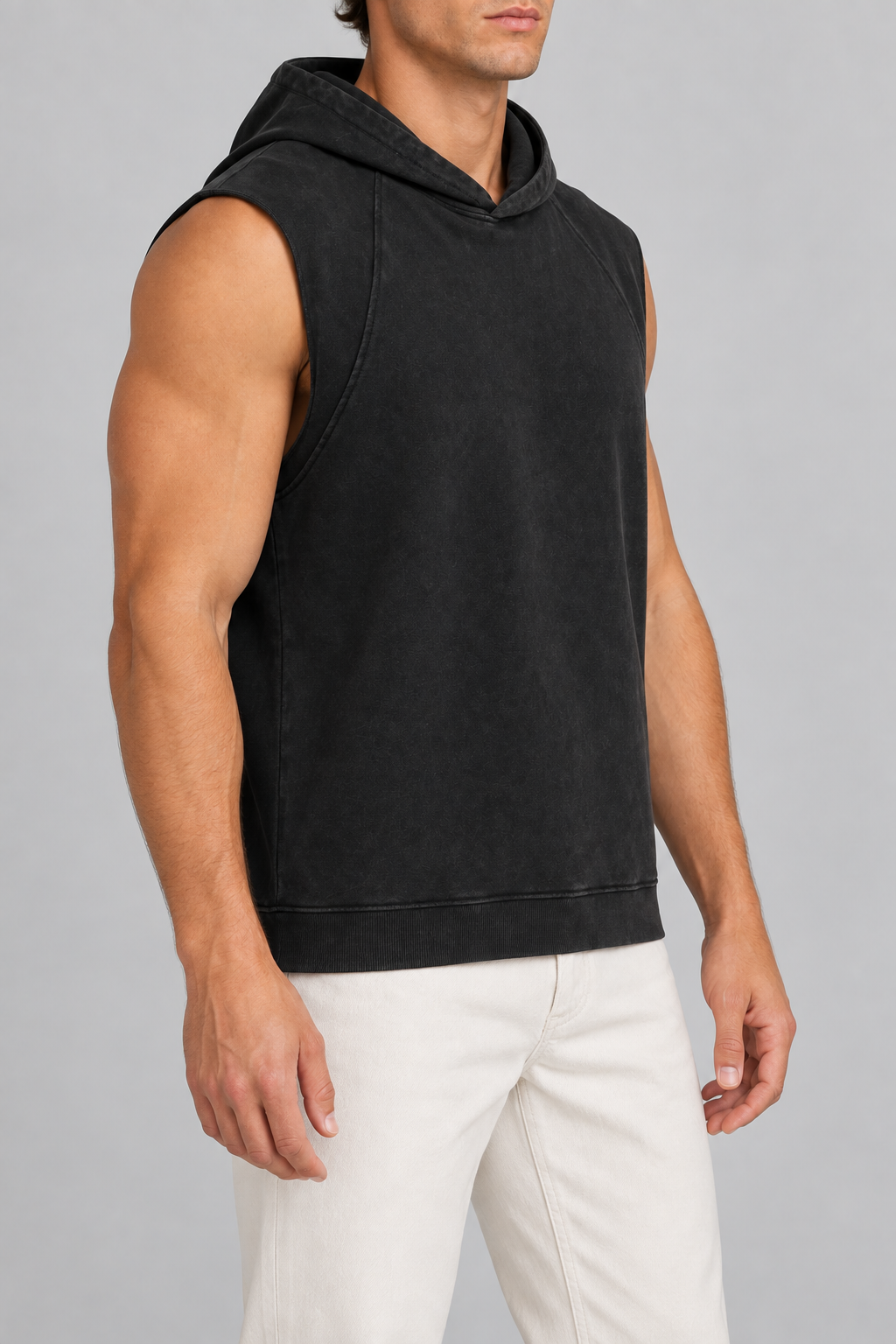Side view of Quiet Drift Sleeveless Hoodie in Black, showing the arm opening, curved panel seam and ribbed hem.