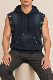 Seated view of Night Current Sleeveless Hoodie in Navy Blue, showing the loose shape and metal-trimmed pocket.