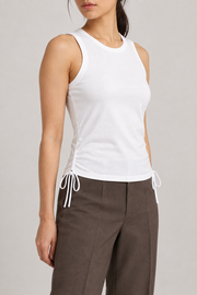 Three-quarter view of Soft Tie Tank in White showing the close fit and side bow.