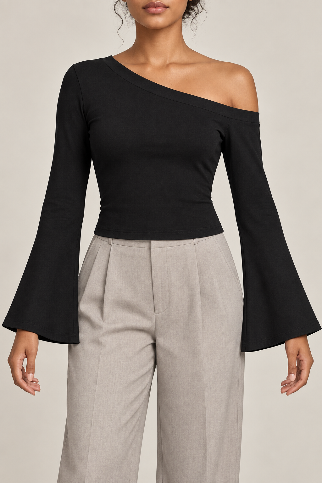 Quiet Arc Bell Sleeve Top in Black. Front view showing the asymmetric neckline and long bell sleeves.