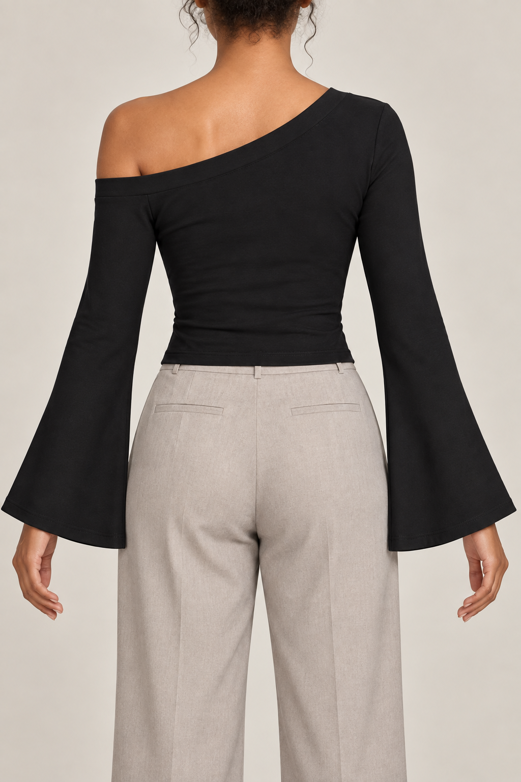 Quiet Arc Bell Sleeve Top in Black. Rear view showing the plain back and open left shoulder.