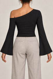 Quiet Arc Bell Sleeve Top in Black. Rear view showing the plain back and open left shoulder.