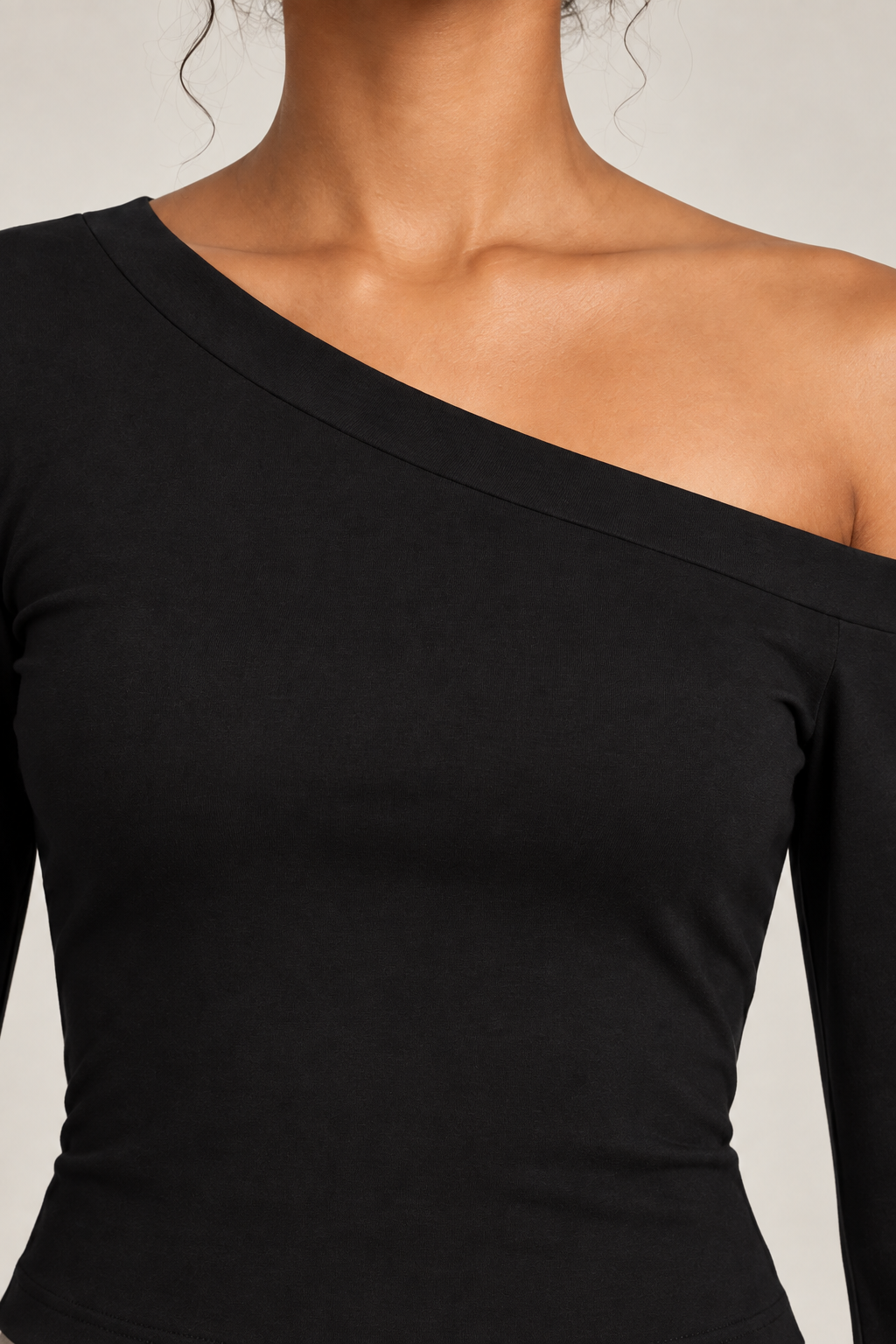 Quiet Arc Bell Sleeve Top in Black. Neckline detail showing the smooth black knit and wide binding.