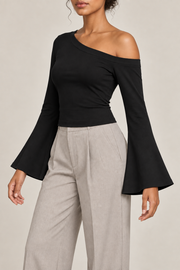 Quiet Arc Bell Sleeve Top in Black. Three-quarter view showing the close fit and flared sleeve opening.
