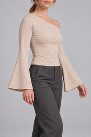 Quiet Arc Bell Sleeve Top in Pale Khaki. Three-quarter view showing the cropped fit and wide sleeve openings.