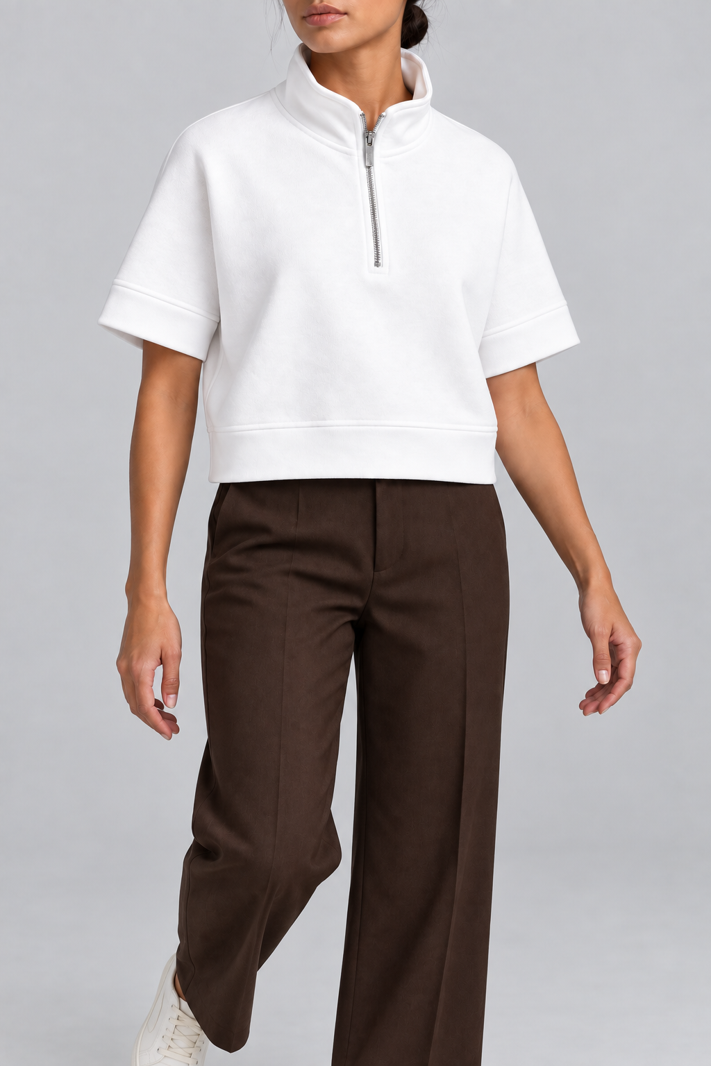 Soft Interval Zip Sweatshirt in White. Walking pose showing the loose cropped shape and short sleeves.