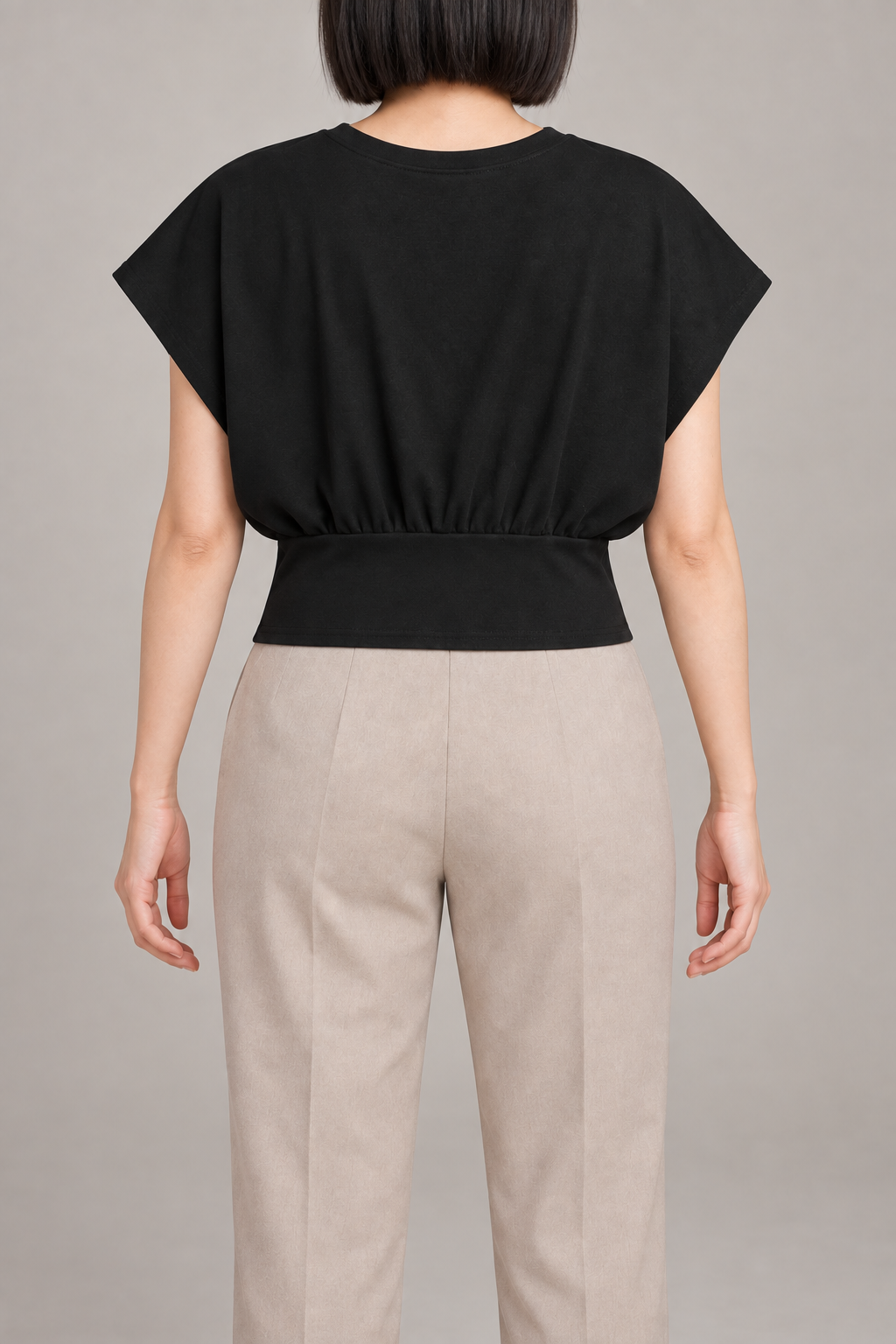 Soft Gather Dolman Top in Black. Rear view showing the plain back gathered into a wide waistband.
