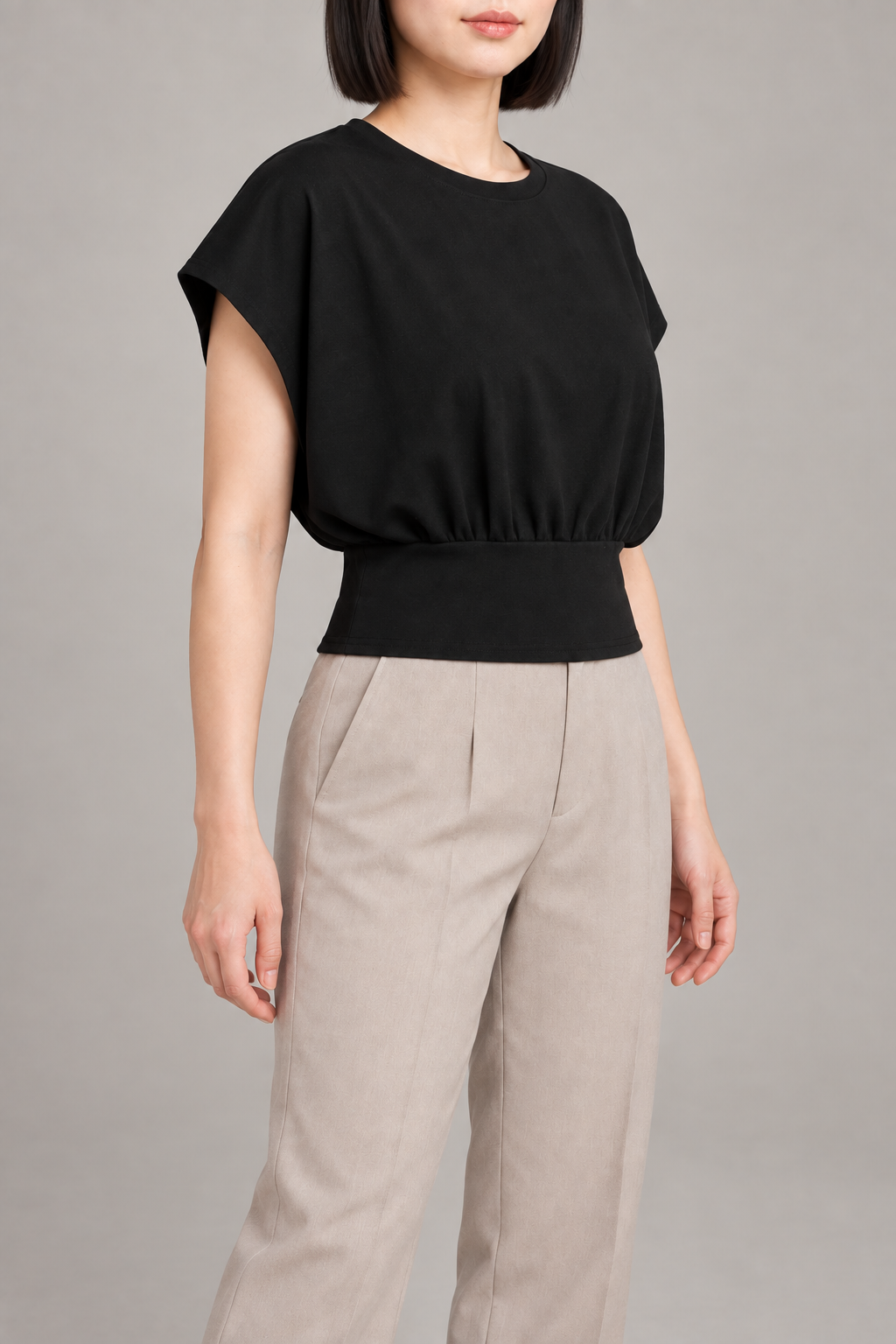 Soft Gather Dolman Top in Black. Three-quarter view showing the dolman armhole and cropped shape.