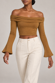 Quiet Fold Bell Sleeve Top in Brown. Walking pose showing the close fit and gentle sleeve flare.