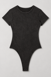 Full front flat-lay of Soft Trace Bodysuit in Washed Black, showing the plain ribbed one-piece shape and high-cut leg openings.