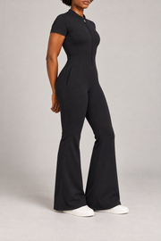 Contour Flare Zip Jumpsuit in Black. Three-quarter side studio view showing the hip pocket and full-length flare.