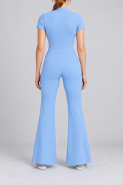 Contour Flare Zip Jumpsuit in Blue. Rear studio view showing the back waist seam and curved shaping above the flared legs.