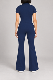 Contour Flare Zip Jumpsuit in Royal Blue. Rear studio view showing the back waist seam and curved shaping above the flared legs.