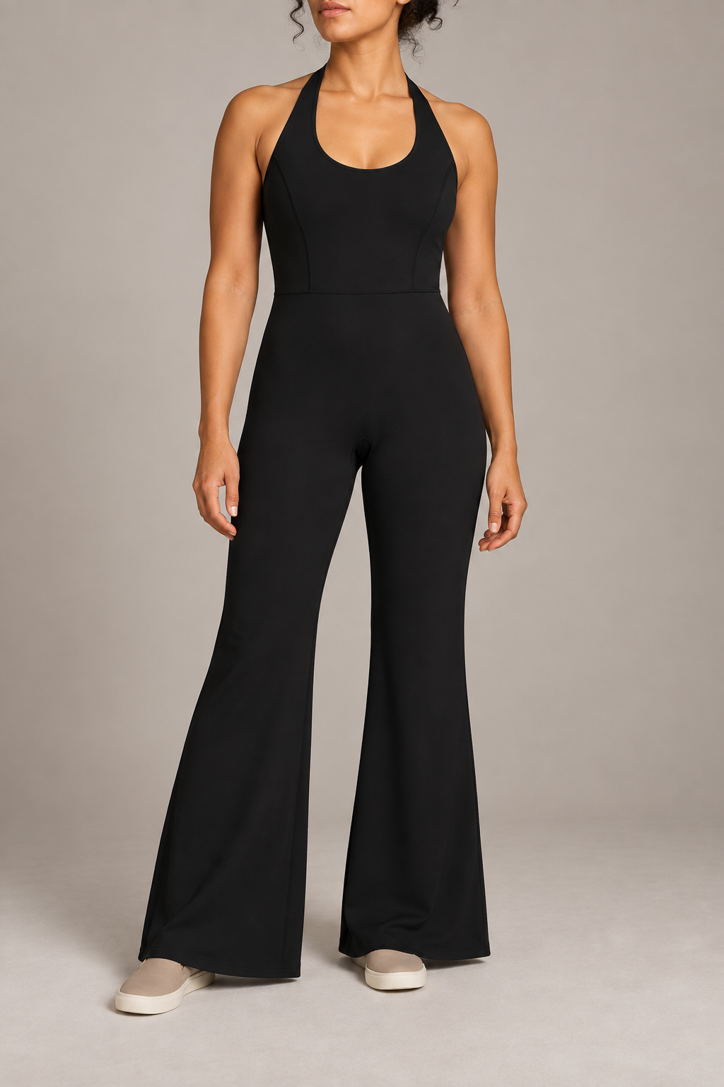 Open Line Halter Jumpsuit in Black. Front studio view showing the halter neckline, plain bodice and full-length flared legs.
