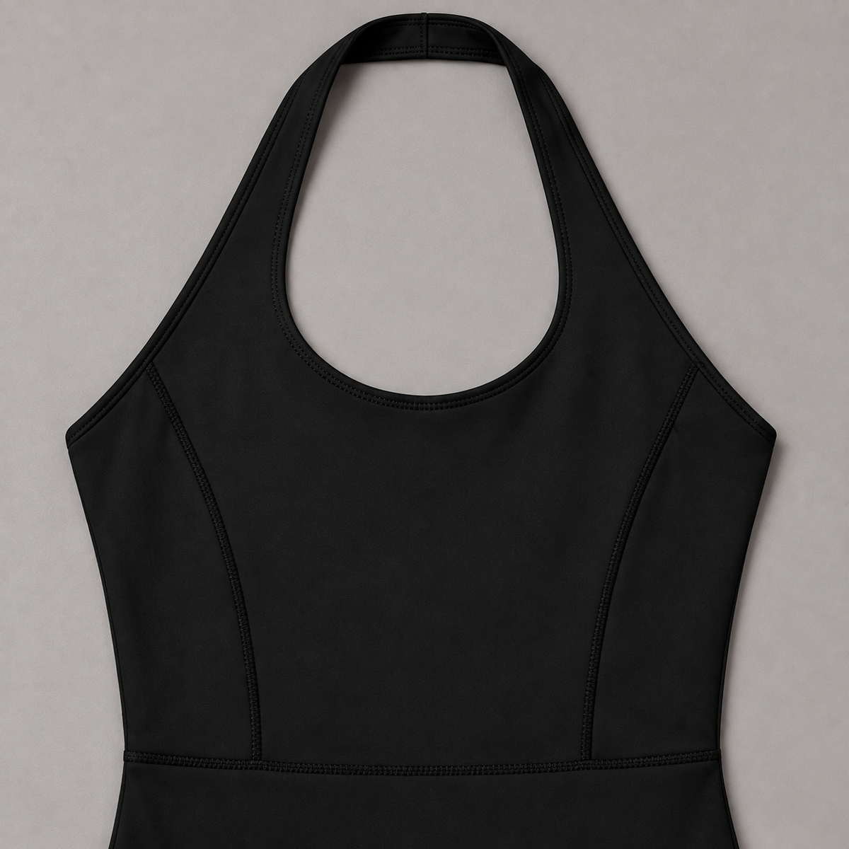 Open Line Halter Jumpsuit in Black. Flat-lay close-up showing the halter neck loop, bound edging and shaped bodice seams.