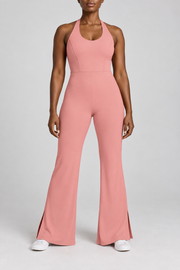 Open Line Halter Jumpsuit in Pink. Front studio view showing the plain halter bodice, fitted waist and flared legs.
