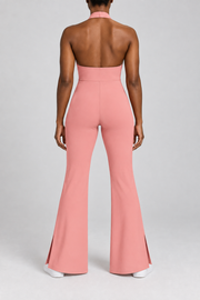 Open Line Halter Jumpsuit in Pink. Rear studio view showing the halter strap, open upper back and plain full-length cut.