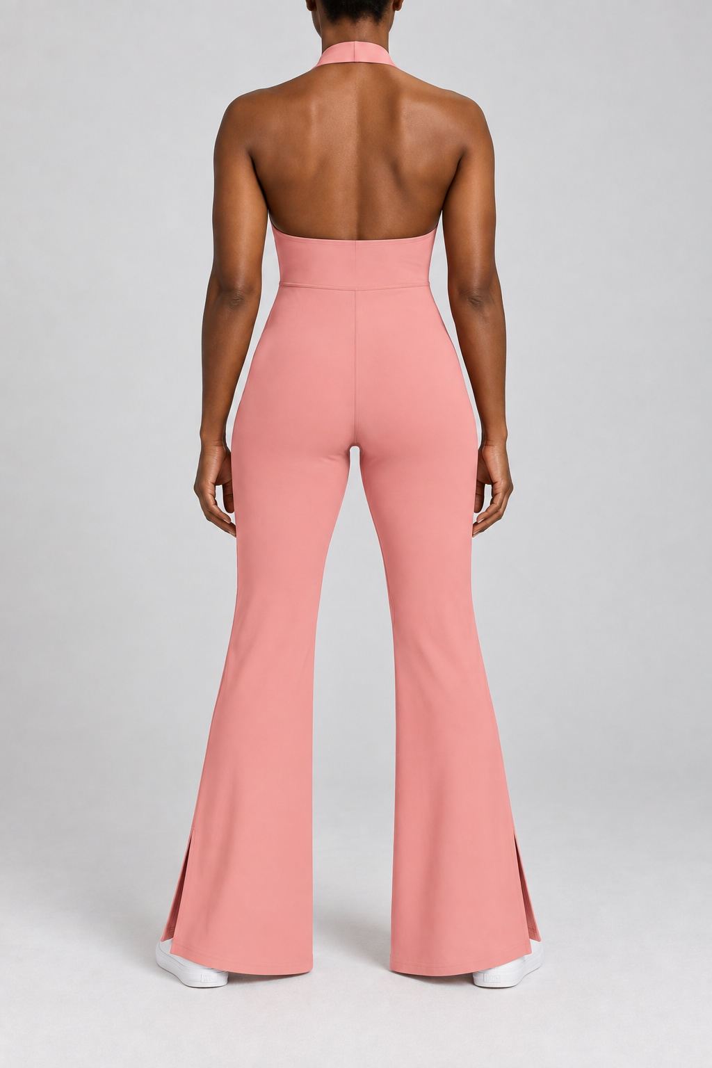Open Line Halter Jumpsuit in Pink. Rear studio view showing the halter strap, open upper back and plain full-length cut.