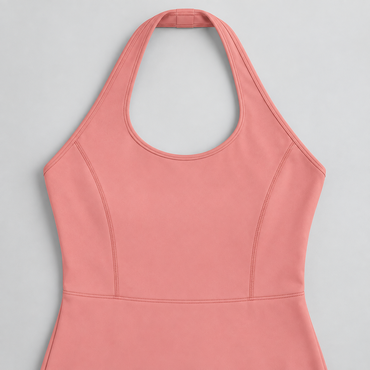 Open Line Halter Jumpsuit in Pink. Flat-lay close-up showing the halter neck loop, bound edging and bodice shaping seams.