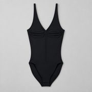 Soft Gather Zip Bodysuit in Black. Front flat-lay studio view showing the ruched V-neckline, center zipper and snap base.