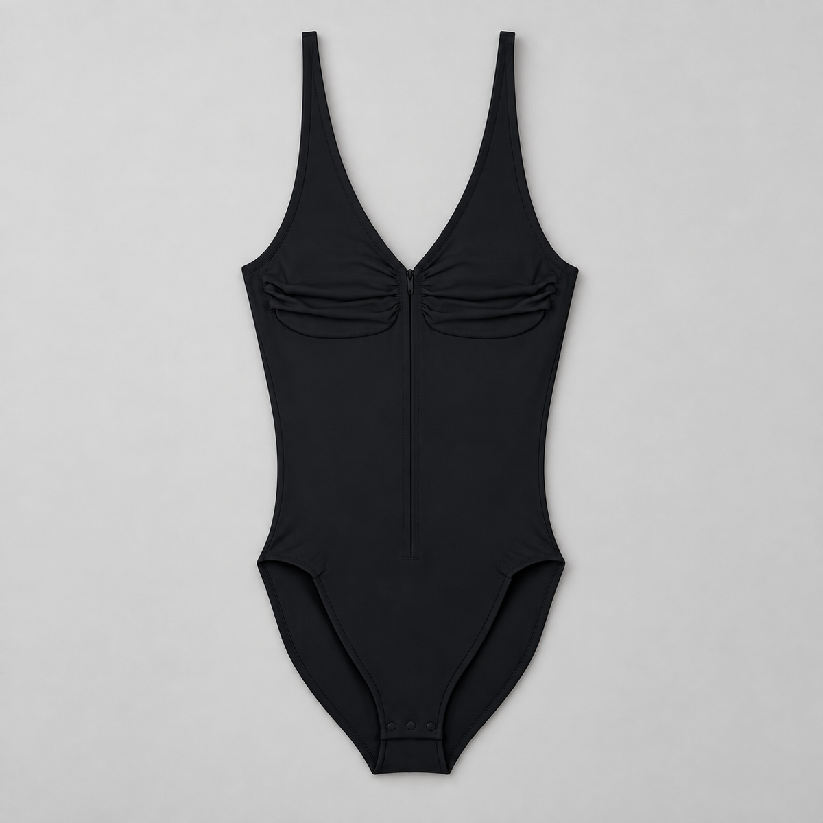Soft Gather Zip Bodysuit in Black. Front flat-lay studio view showing the ruched V-neckline, center zipper and snap base.