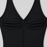 Soft Gather Zip Bodysuit in Black. Close-up studio view showing the gathered fabric, V-neck edging and black zipper.