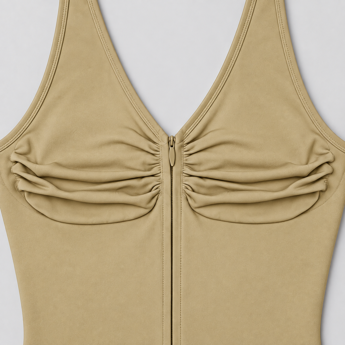 Soft Gather Zip Bodysuit in Khaki. Close-up studio view showing the ruched fabric, V-neck edging and matching zipper.