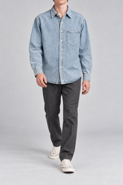 Walking studio view of Worn Line Denim Shirt in Blue, showing its relaxed plain silhouette and natural fabric drape.