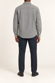 Rear view of Worn Line Denim Shirt in Light Gray, showing the stitched back yoke, side pleats and curved hem.