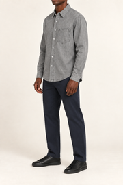 Three-quarter view of Worn Line Denim Shirt in Light Gray, showing the plain washed finish, long sleeves and curved hem.