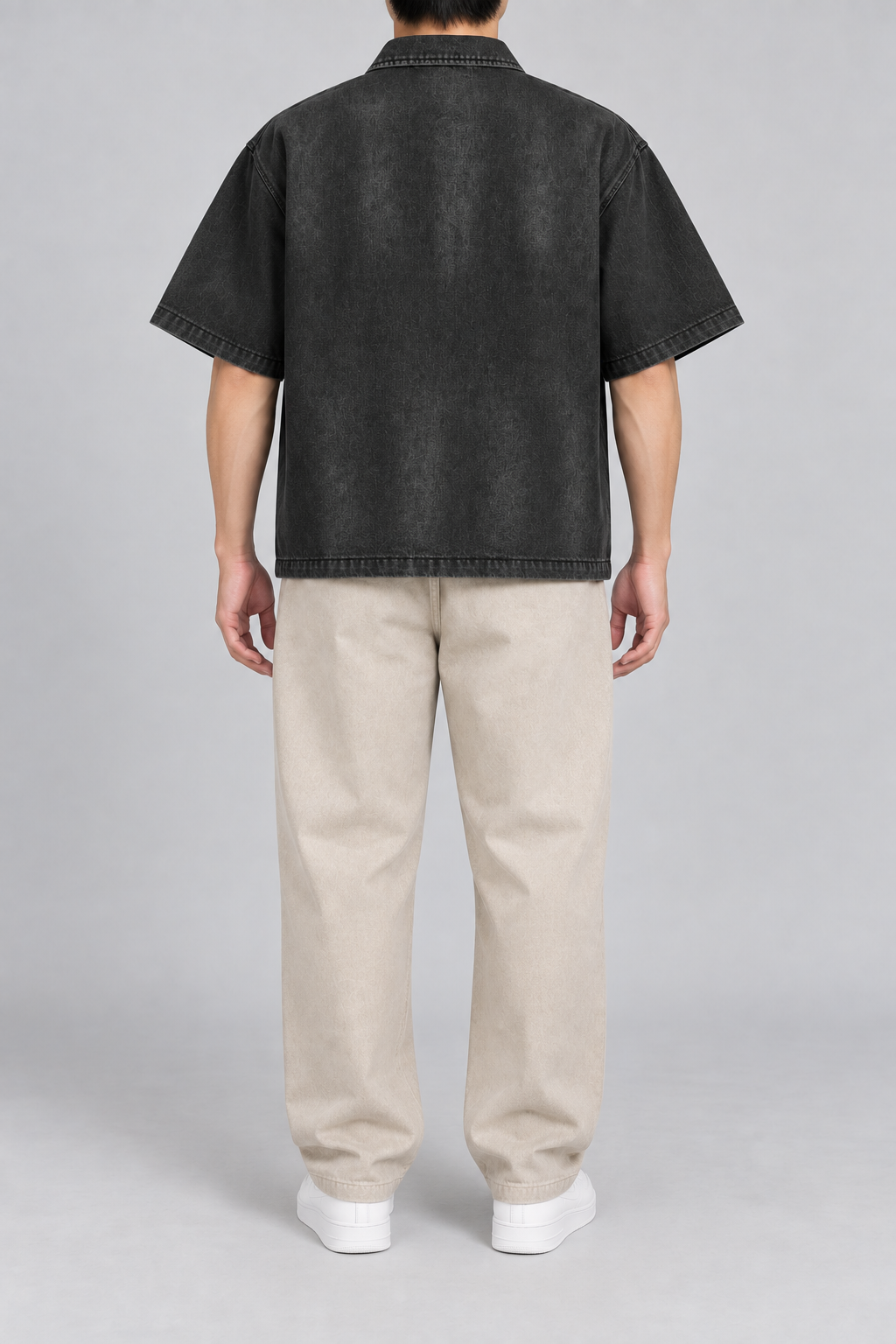 Rear view of Quiet Shift Zip Denim Shirt in Black, showing the plain back, dropped shoulders and straight hem.