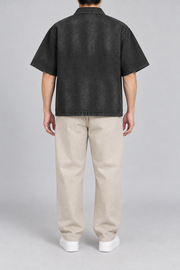 Rear view of Quiet Shift Zip Denim Shirt in Black, showing the plain back, dropped shoulders and straight hem.