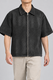 Walking view of Quiet Shift Zip Denim Shirt in Black, showing the loose short-sleeve shape and natural drape.