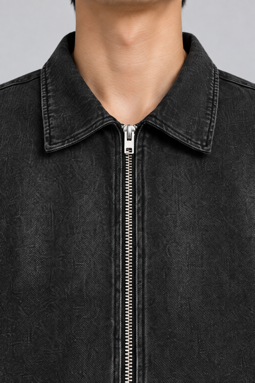 Close detail of Quiet Shift Zip Denim Shirt in Black, showing the pointed collar, silver zip and washed denim texture.