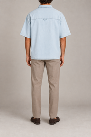 Rear view of Pale Current Lyocell Shirt in Light Blue, showing the back yoke, small hanging loop and straight hem.