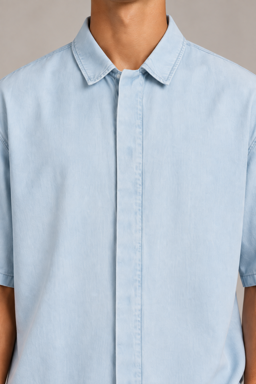 Detail of Pale Current Lyocell Shirt in Light Blue, showing the pointed collar, concealed placket and smooth washed texture.