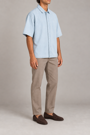 Three-quarter view of Pale Current Lyocell Shirt in Light Blue, showing the wide short sleeves and clean, plain silhouette.