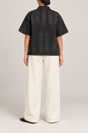 Rear view of Soft Shift Zip Denim Shirt in Black, showing the plain pocket-free back and straight stitched hem.