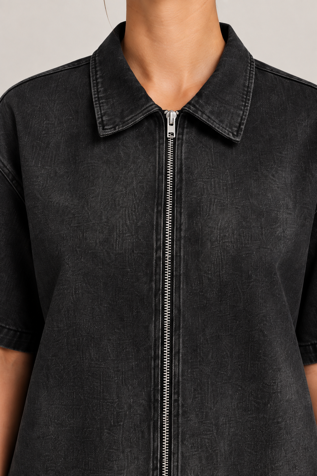 Detail of Soft Shift Zip Denim Shirt in Black, showing the pointed collar, silver zip and washed denim texture.