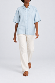 Walking view of Soft Current Lyocell Shirt in Light Blue, showing the loose plain silhouette and soft fabric drape.