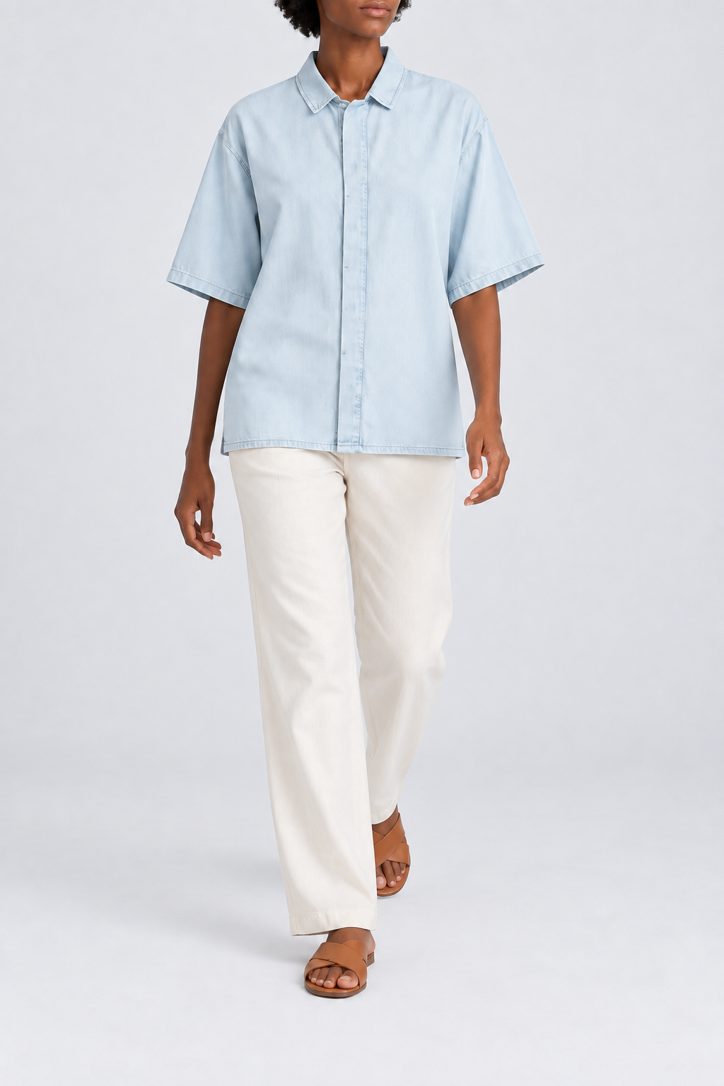 Walking view of Soft Current Lyocell Shirt in Light Blue, showing the loose plain silhouette and soft fabric drape.