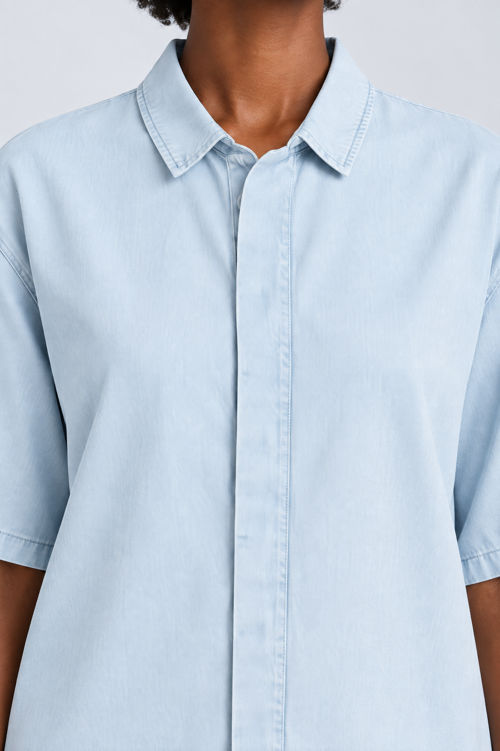 Detail of Soft Current Lyocell Shirt in Light Blue, showing the pointed collar, concealed placket and washed texture.
