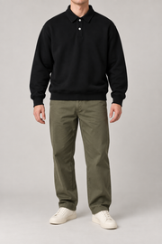 Front view of Quiet Club Polo Sweatshirt in Black, showing the plain design, two-button collar and ribbed hem.