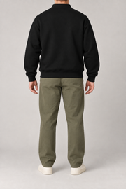 Rear view of Quiet Club Polo Sweatshirt in Black, showing the plain back, dropped shoulders and ribbed cuffs.