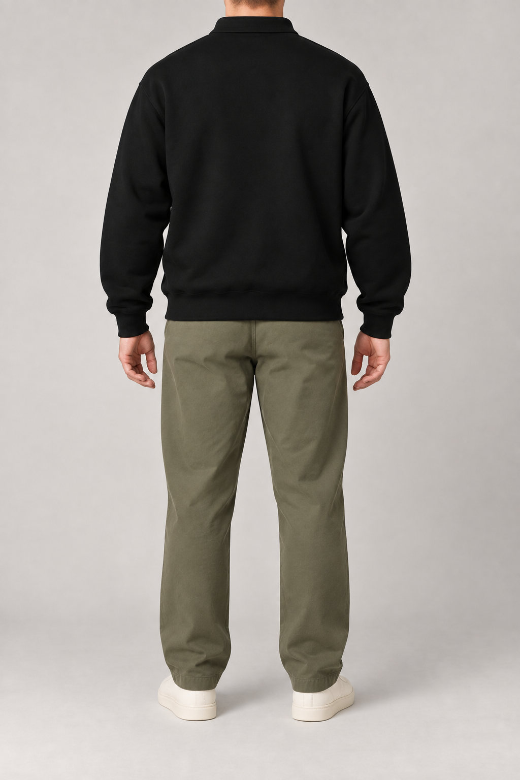 Rear view of Quiet Club Polo Sweatshirt in Black, showing the plain back, dropped shoulders and ribbed cuffs.