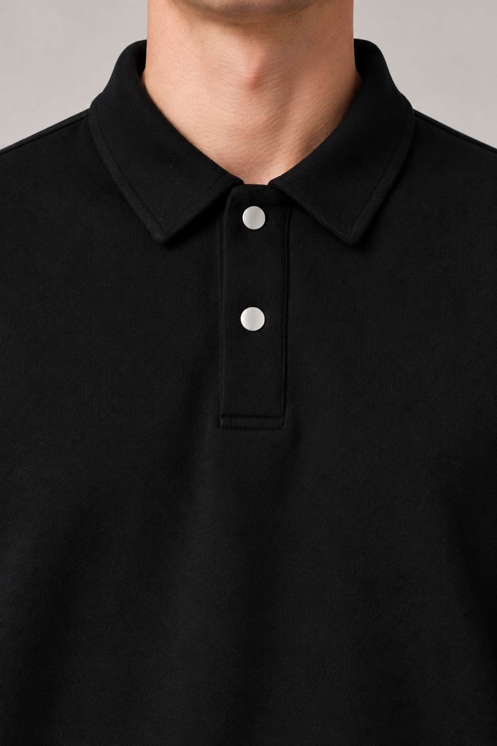 Close detail of Quiet Club Polo Sweatshirt in Black, showing the polo collar, two pale buttons and soft fabric texture.